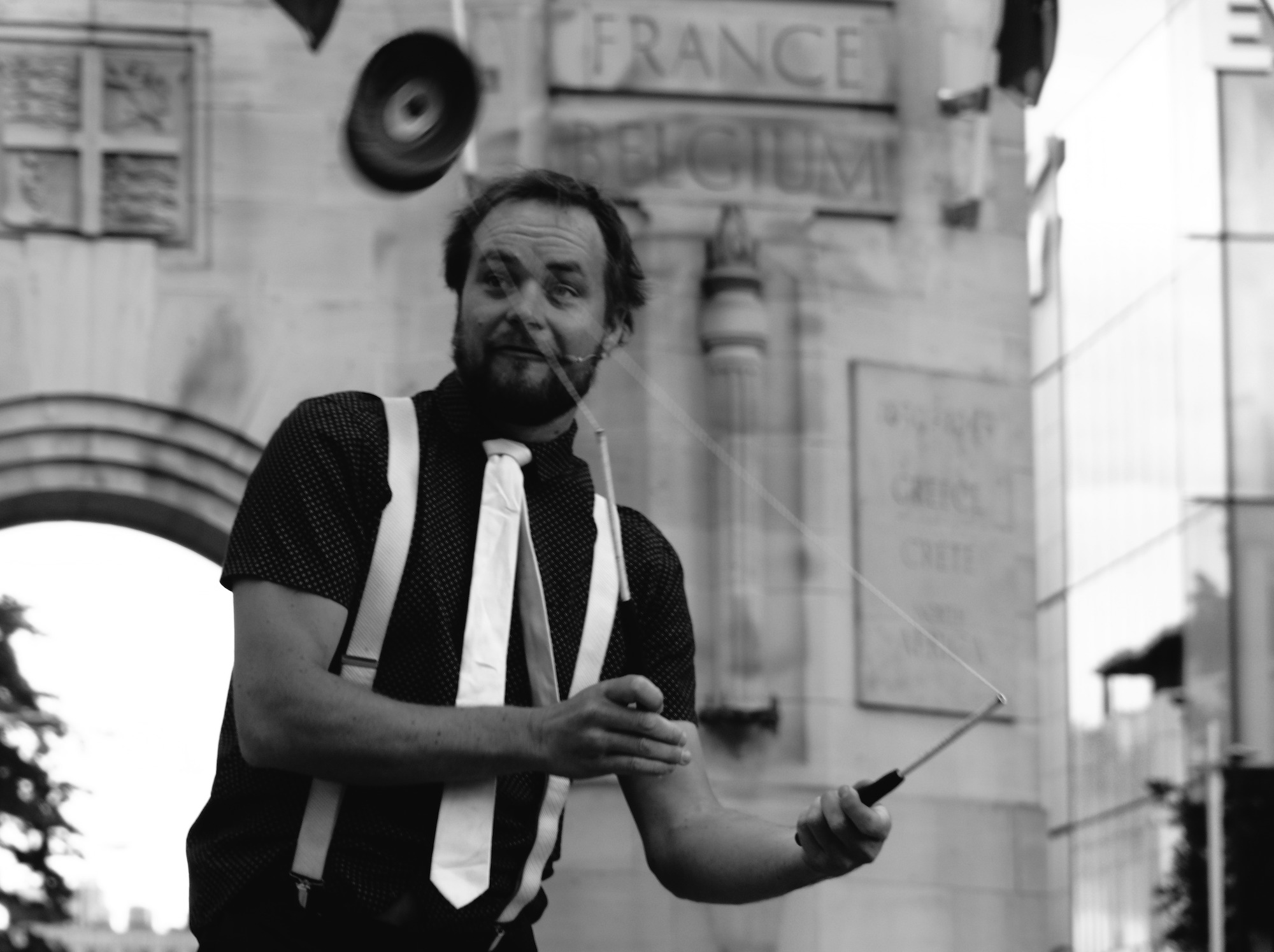 Man juggling a diabolo in front of the Remembrance Arch, commemorating war victims, Christchurch.