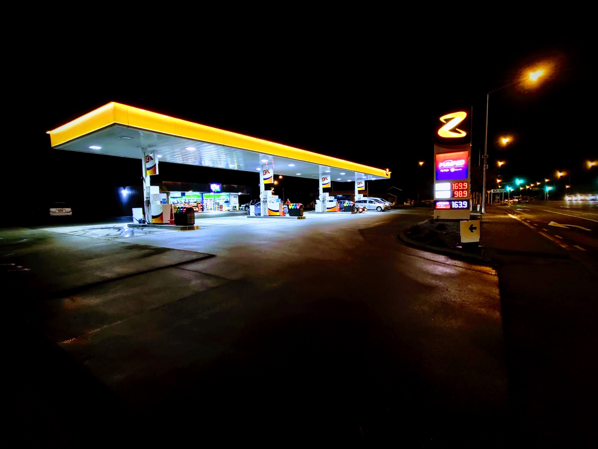 Service station at night, with yellow and white roof, eight pumps and a big Z sign with fuel prices, Christchurch.