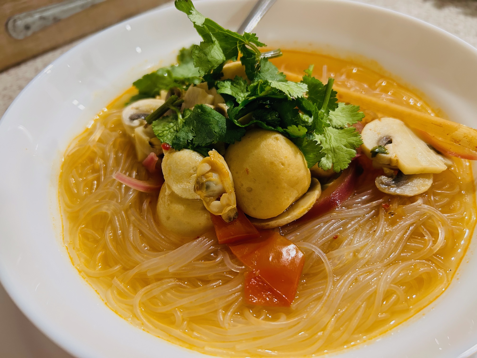 A comforting plate of soup and glass noodles.